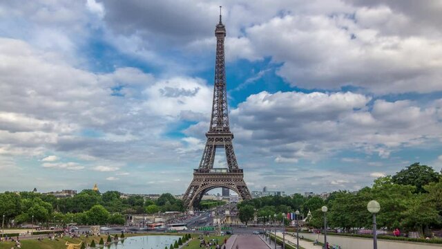 Fountains on famous square Trocadero with Eiffel tower in the background timelapse hyperlapse. Trocadero and Eiffel tower are the most visited attractions of Paris. Blue cloudy sky at summer day