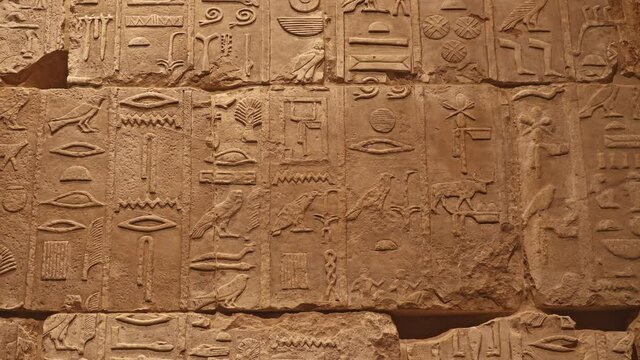 Stone wall with ancient Egyptian hieroglyphs