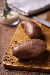 Red potato presented on a wooden board