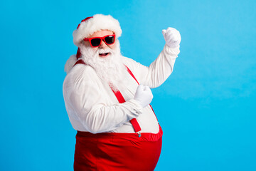 Fototapeta na wymiar Photo of style stylish fat santa claus with big belly beard raise fists win x-mas christmas lottery wear suspenders overalls sunglass isolated over blue color background