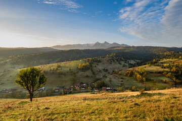 Iconic autumn colourful landscape photo of the village under the mountains. Travelling concept background. Super image of morning landscape.