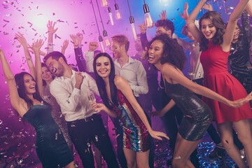 Photo of careless people celebrate pretty girls dance floor falling confetti wear stylish outfit modern club indoors