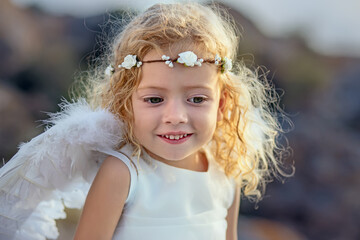 Beautiful little girl with angelic wings
