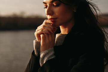 Quiet woman dreaming on lake shore