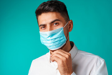 Handsome mixed-race man wearing medical face mask