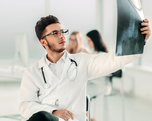 happy doctor radiologist looks at the x-ray