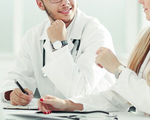 doctors colleagues talking sitting at a table in the office