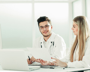 doctors colleagues talking sitting at a table in the office