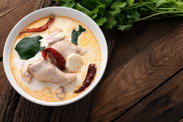 Tom kha kai or tom kha gai, traditional Thai food soup chicken on wood