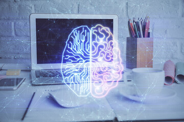 Double exposure of work space with computer and human brain drawing hologram. Brainstorm concept.
