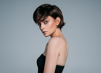 Portrait of a young beautiful brunette girl with stylish short hair