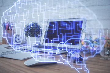 Double exposure of work space with computer and human brain drawing hologram. Brainstorm concept.