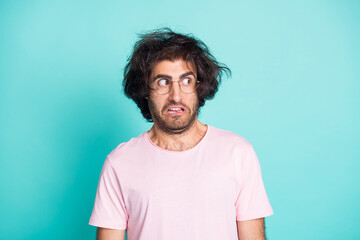 Portrait of speechless crazy guy looking empty space wear spectacles pastel pink t-shirt isolated...