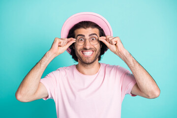 Photo portrait of crazy mad man staring grinning white teeth taking off eyewear isolated on vivid turquoise color background