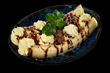 Ice cream vanila and chocolate souce banana dessert.