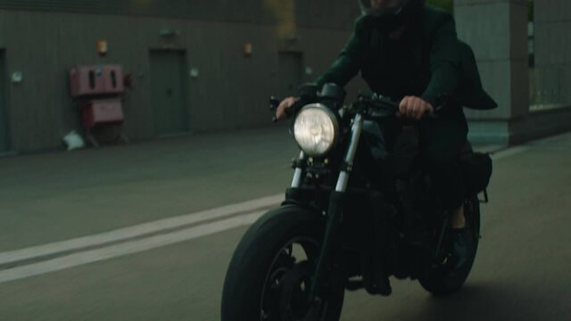 a motorcyclist in a suit drives a bike in the city