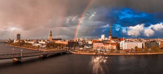 Rain shower over Riga, Latvia at sunset. Aerial view of the Riga old town at dusk with stormy...