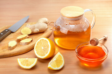  Ginger tea preparation with healthy ingredients on wooden background.