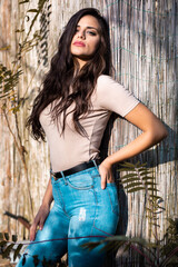 Fototapeta premium Portrait of a beautiful brunette girl in jeans