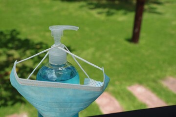 Medical protective mask and alcohol antiseptic gel using to health protection from corona virus,  covid-19. Use mask all time go outside home. Healthcare and object concept.