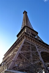 City sign of the Paris, France: Eiffel. Statue of Eiffel made of full metal and steel, Paris ,France during light cloudy day and blue sky. 