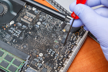 Service engineer fixing laptop. Repairing laptop concept. Close up view.