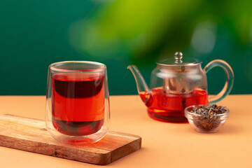 Glass teapot and cup with black tea