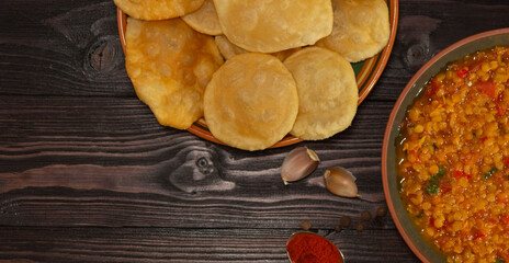 Indian cuisine. Luchi tortillas with cooked vegetables.