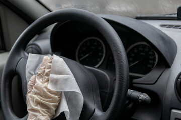Child hand in rubber glove disinfects car wheel as infection control and infection prevention for...