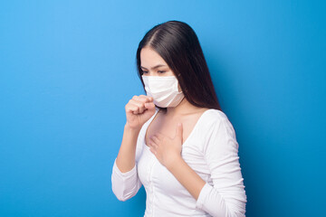 portrait of young woman is wearing face mask on Blue background