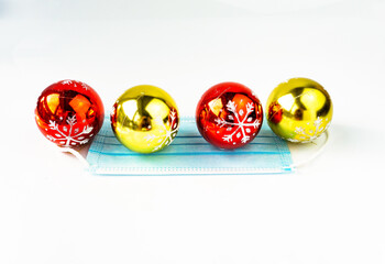 Christmas decoration with medical mask on white background. 2020 Christmas under Covid-19.