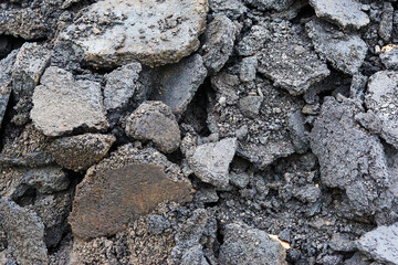 Broken pieces of asphalt at a construction site. Recycling and reuse crushed concrete rubble, asphalt, building material, blocks. Crushed сoncrete Background. 
