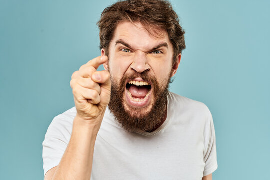 Bearded man emotions facial expression gestures hands close-up blue background