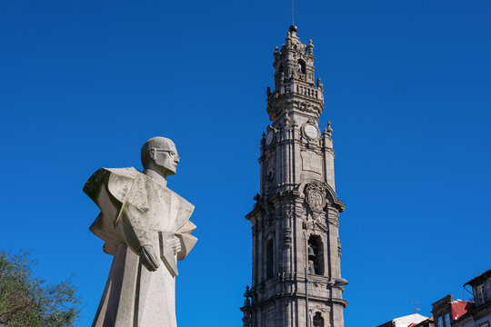 Porto, Portugal - February 21, 2017: Torre dos Clérigos and the statue of the Roman Catholic Bishop António Gomes Ferreira. The iconic Clerigos Tower on a sunny day. 