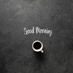 goog morning coffee cup on dark stone background from above with space for text