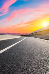 Asphalt viaduct road and city skyline in Hangzhou at sunset.
