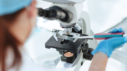 close up. researcher testing the blood under a microscope.