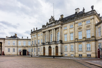 Fototapeta na wymiar Amalienborg Palace (1760) - home of the Danish royal family. Royal Palace consists of four identical classical palace facades. Copenhagen, Denmark.