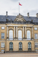 Fototapeta na wymiar Amalienborg Palace (1760) - home of the Danish royal family. Royal Palace consists of four identical classical palace facades. Copenhagen, Denmark.