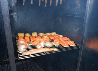 Halibut and salmon fish gets smoked in a oven