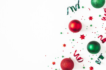 Christmas composition. Red and green decorations on white background. Christmas, winter, new year concept. Flat lay, top view, copy space