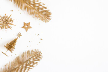 Christmas composition. Golden decorations on white background. Christmas, winter, new year concept. Flat lay, top view, copy space