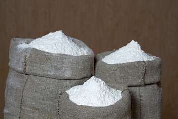 Bags of wheat flour on a brown background