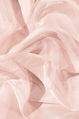 Light pink abstract satin background with folds.