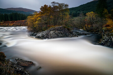 long exposure shot of the waterfalls in glen orchy near bridge of orchy in the argyll region of the highlands of scotland during autumn