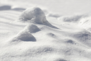 Fototapeta na wymiar Fairy snowy landscape background. Winter meadow snow hills, sunny day weather. Selective focus.