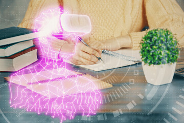 AR hologram over woman's hands taking notes background. Concept of augmented reality. Multi exposure