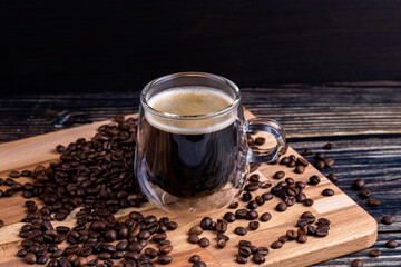 Coffee mug on wooden board and coffee beans