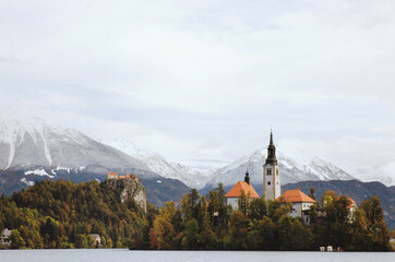 View of the snow-capped mountain peaks against the backdrop of lake Bled.