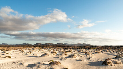 Sand dunes, mountains and clouds - El Cotillo - Fuerteventura landscape